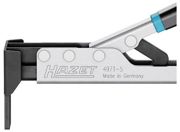 De afbeelding toont een metalen gereedschap gelabeld als 'Hazet 4971-5 Made in Germany' met een gedeeltelijk zichtbare zwarte handgreep.