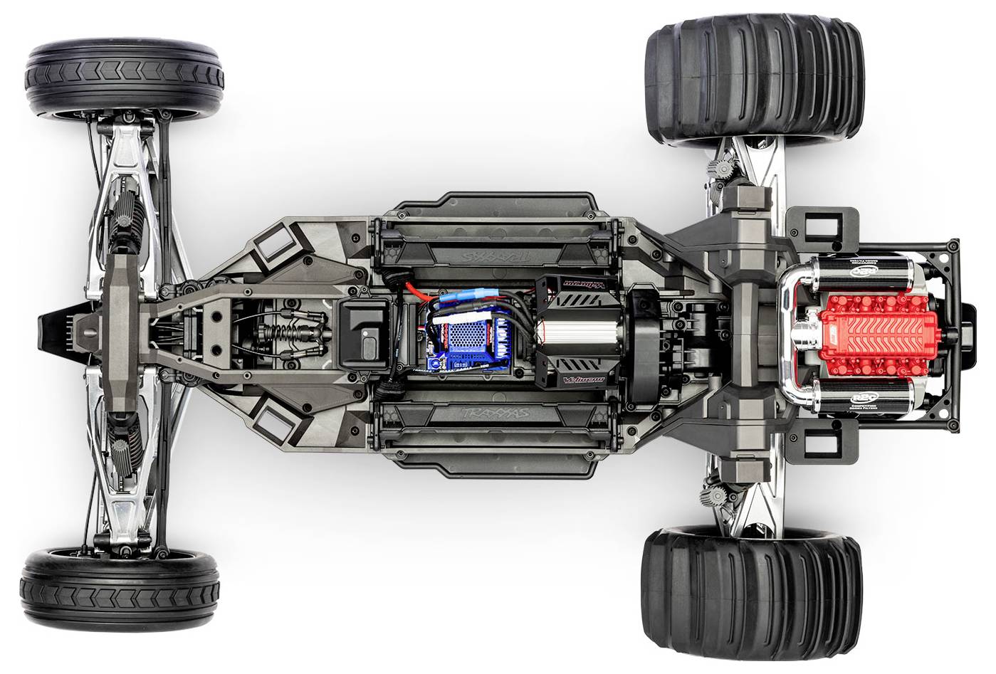 Bovenaanzicht van een auto-chassis waarbij componenten zichtbaar zijn: grote banden, ophanging, aandrijflijn en een blootgestelde motor met zichtbare bedrading.