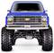 Blauwe opgetilde truck met grote banden en een 'USA1' kenteken, gezien van voren, met een chroom grille en ophanningscomponenten.