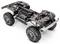 'Terreinvoertuig chassis met grote banden, zichtbaar veersysteem en blootliggende mechanische componenten. Geen carrosserie of interieur te zien.'