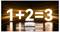 Een oplichtende vergelijking '1 + 2 = 3' staat boven een kleine, zilveren apparaat op een reflecterende ondergrond, afgezet tegen een achtergrond van oranje lichtstrepen.