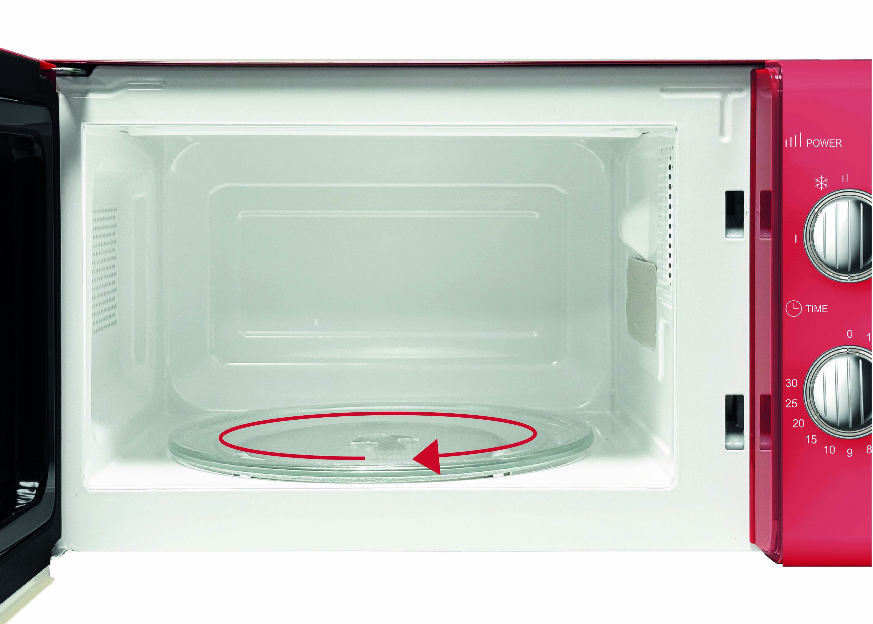 Open magnetron met een glazen draaiplateau en een rode pijl die de roteerrichting aangeeft. Bedieningsknoppen voor vermogen en tijd zijn zichtbaar aan de zijkant.