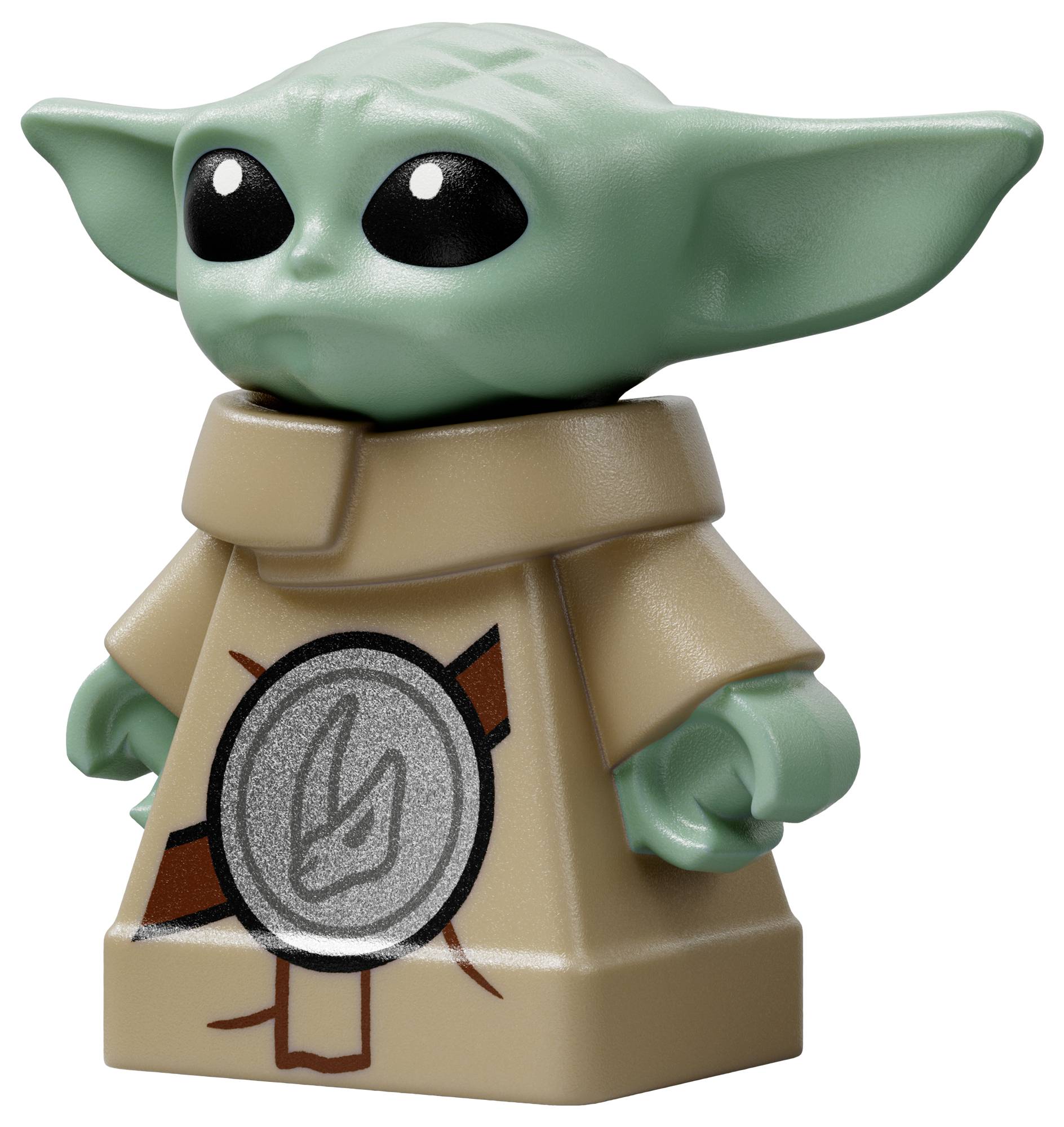 Een groen speelgoedfiguur met grote oren en zwarte ogen, gekleed in een beige outfit versierd met een rond embleem op de voorkant.