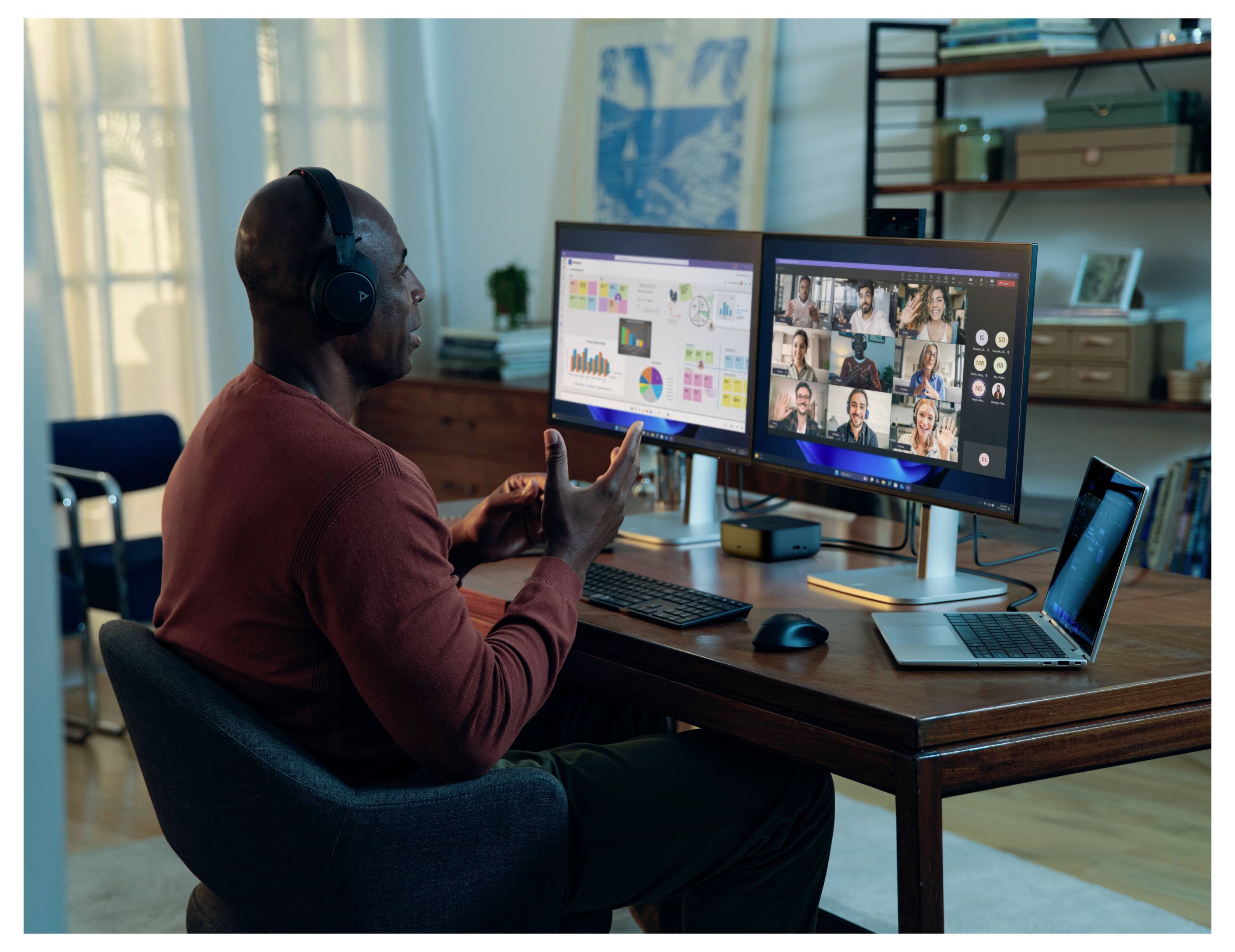 Een persoon in een videogesprek met meerdere deelnemers weergegeven op een computermonitor, terwijl spreadsheetgegevens zichtbaar zijn op een ander scherm.
