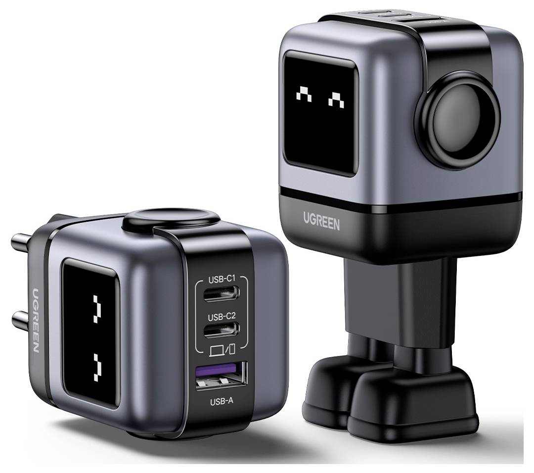 'Twee zwart-grijze robotvormige USB-laadapters met vierkante koppen, één aangesloten, één staande op afneembare poten, beide met digitale ogen.'