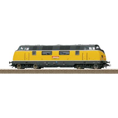 Een model van een geel en zwart diesellocomotief op een spoor, met twee ventielen en een rood bord met tekst aan de zijkant.