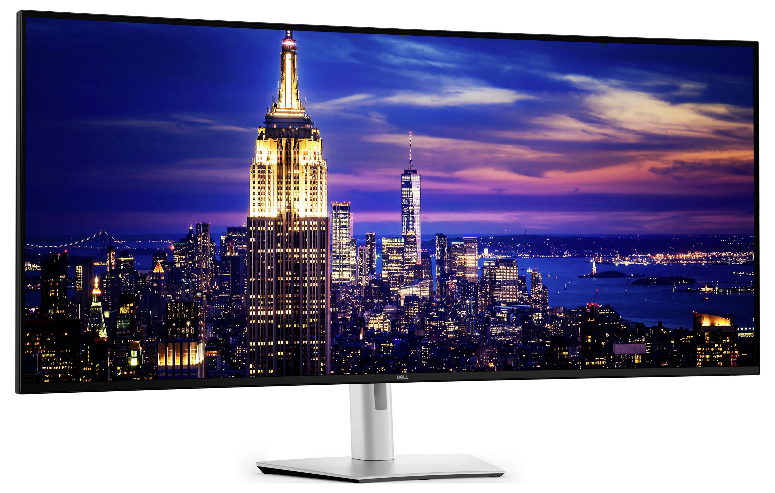 Een breedbeeldcomputermonitor toont een levendige stadslandschap tijdens de schemering, met verlichte wolkenkrabbers en een opvallende gloeiende toren.