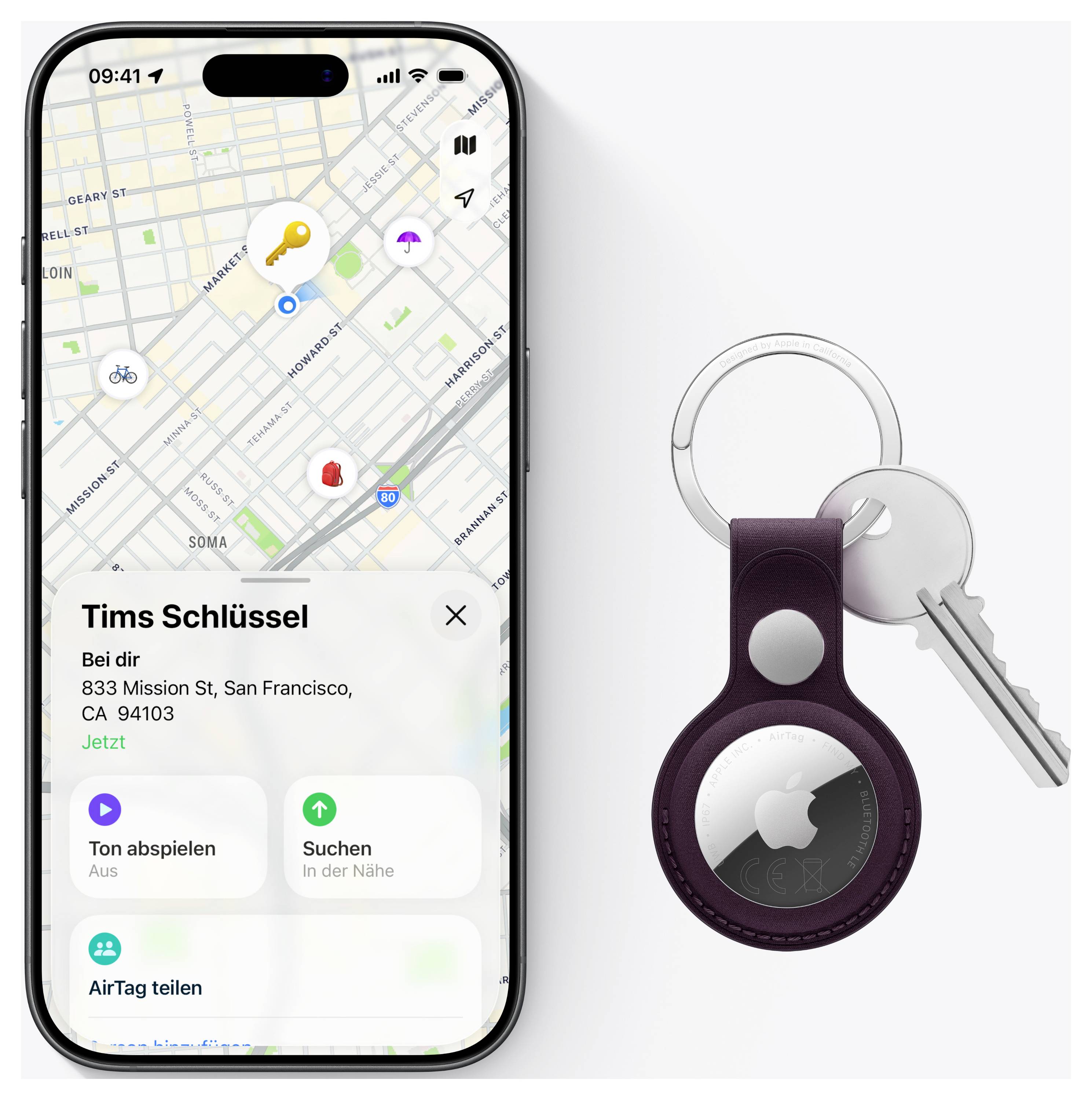 'Een kaart op een smartphone toont de locatie van 'Tims Schlüssel' op 833 Mission St, San Francisco. Ernaast een paarse sleutelhanger met een AirTag en sleutels.'