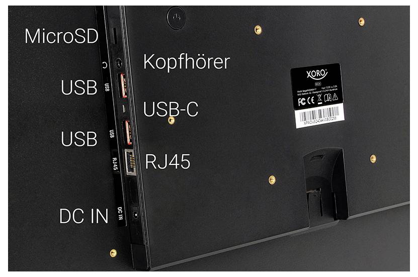 Het afbeelding toont het zijpaneel van een monitor met verschillende poorten met labels: MicroSD, USB, USB-C, Kopfhörer (koptelefoon), RJ45, en DC IN.