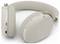Beige over-ear draadloze koptelefoon met stof bespannen hoofdband, bedieningselementen op het oor, en rode statusindicatoren getoond op een witte achtergrond
