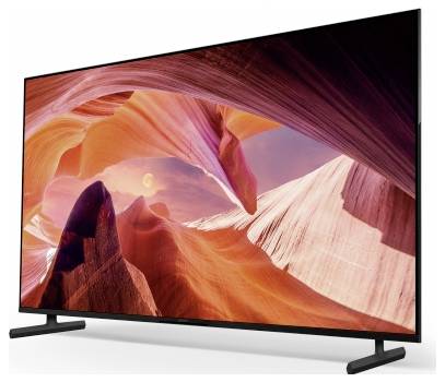 Flatscreen-televisie die een levendige canyonlandschap weergeeft met rode, oranje en roze rotsformaties