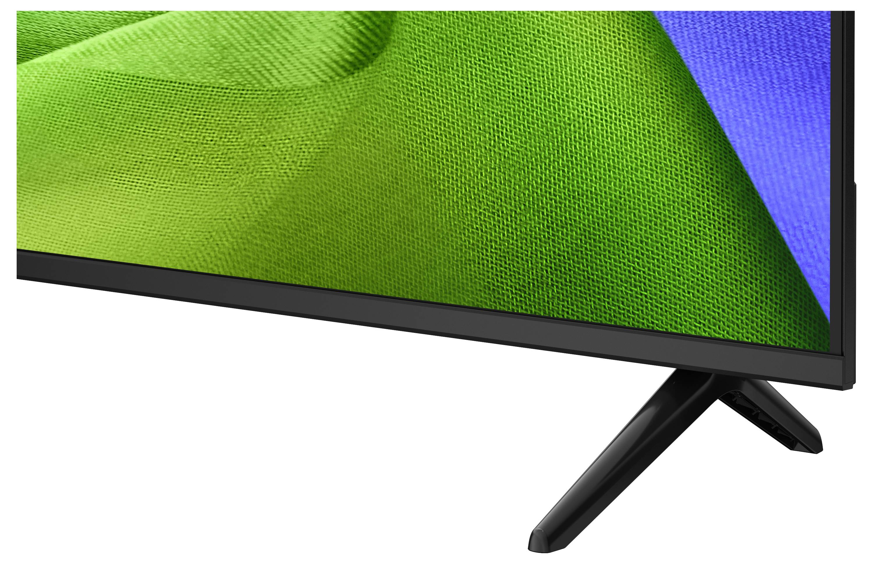 Close-up van een flatscreen-tv of monitor met een groen en blauw abstract beeld, met de zwarte standaard zichtbaar op een witte achtergrond.