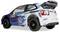 Witte Volkswagen Polo rallycross auto met blauwe grafische elementen, 'WALES' sticker en achtervleugel, afgebeeld in achter driekwart aanzicht tegen een eenvoudige achtergrond.