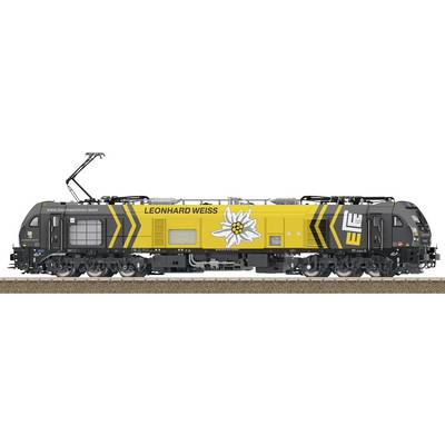 Geel en zwarte LEONHARD WEISS spoorweglocomotief met groot wit bloemlogo, weergegeven van opzij op spoorrails.