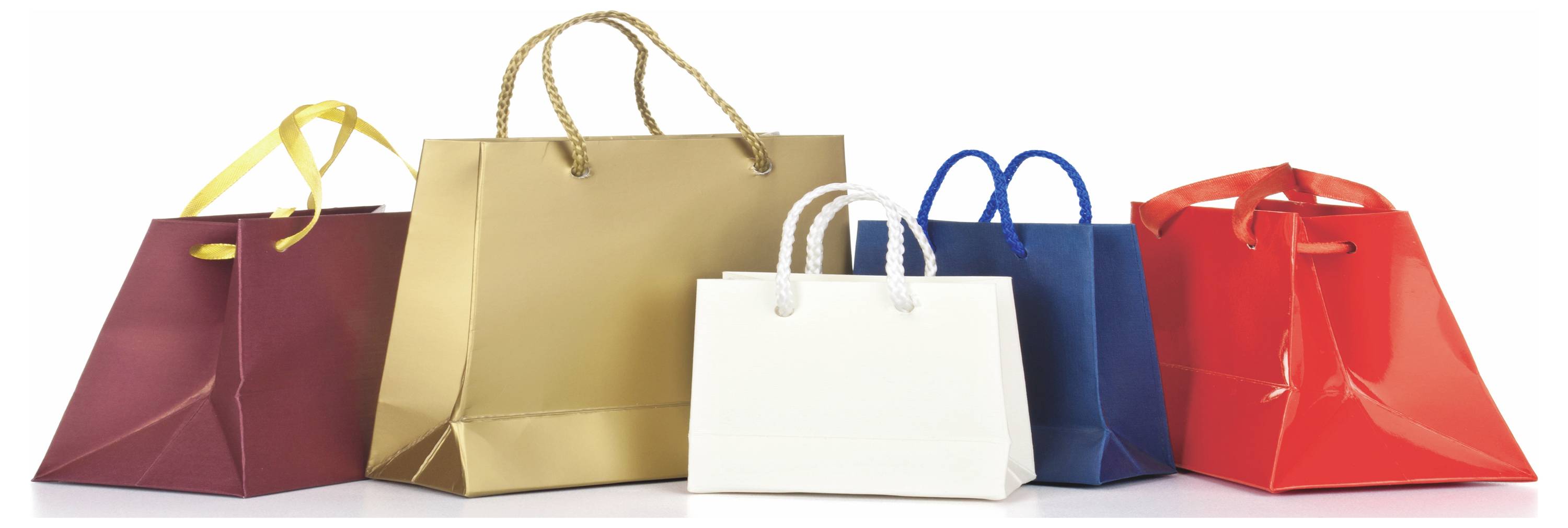 Vijf kleurrijke boodschappentassen op een witte achtergrond opgesteld, wat duidt op detailhandelaankopen of cadeauwinkel winkelen.