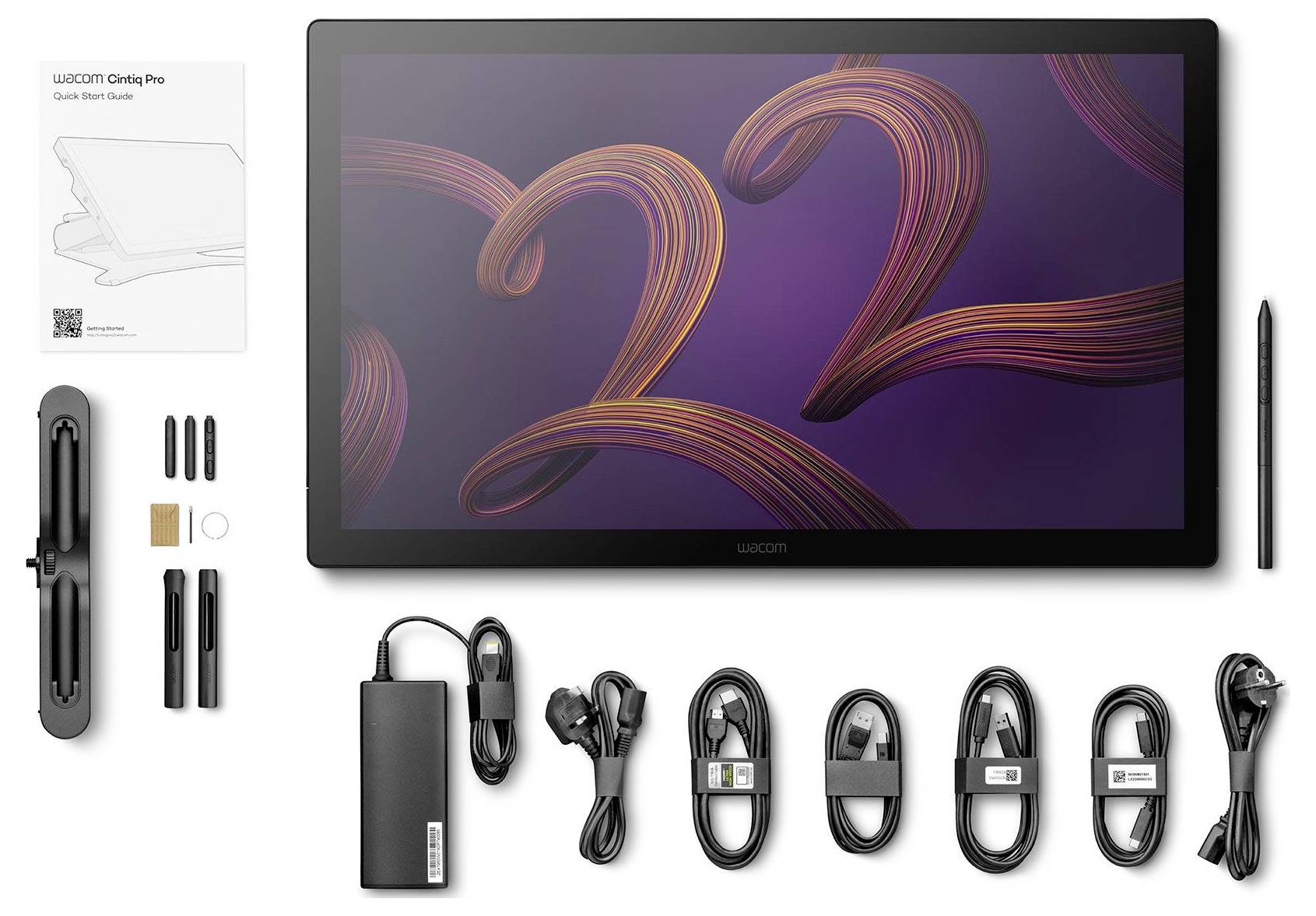 Een Wacom-pentablet weergegeven met bijbehorende accessoires: stylus, stroomadapter, kabels, punten en snelstartgids.