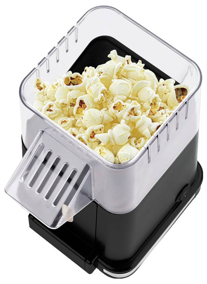 Een zwarte tafelblad popcornmachine met een transparante deksel en een afneembaar dienblad vol gepopt popcorn.