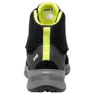 Zwart-grijze atletische schoen van achteren getoond, met neongeelvoering en een verticaal hakenlabel.