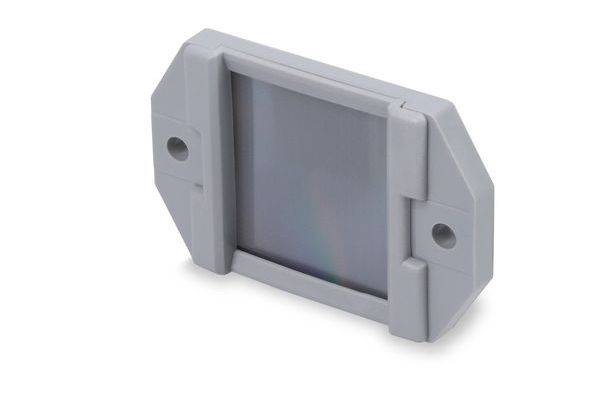 Grijs plastic rechthoekig machinepaneel of afdekking met twee zijmontagegatene, weergegeven op een witte achtergrond.