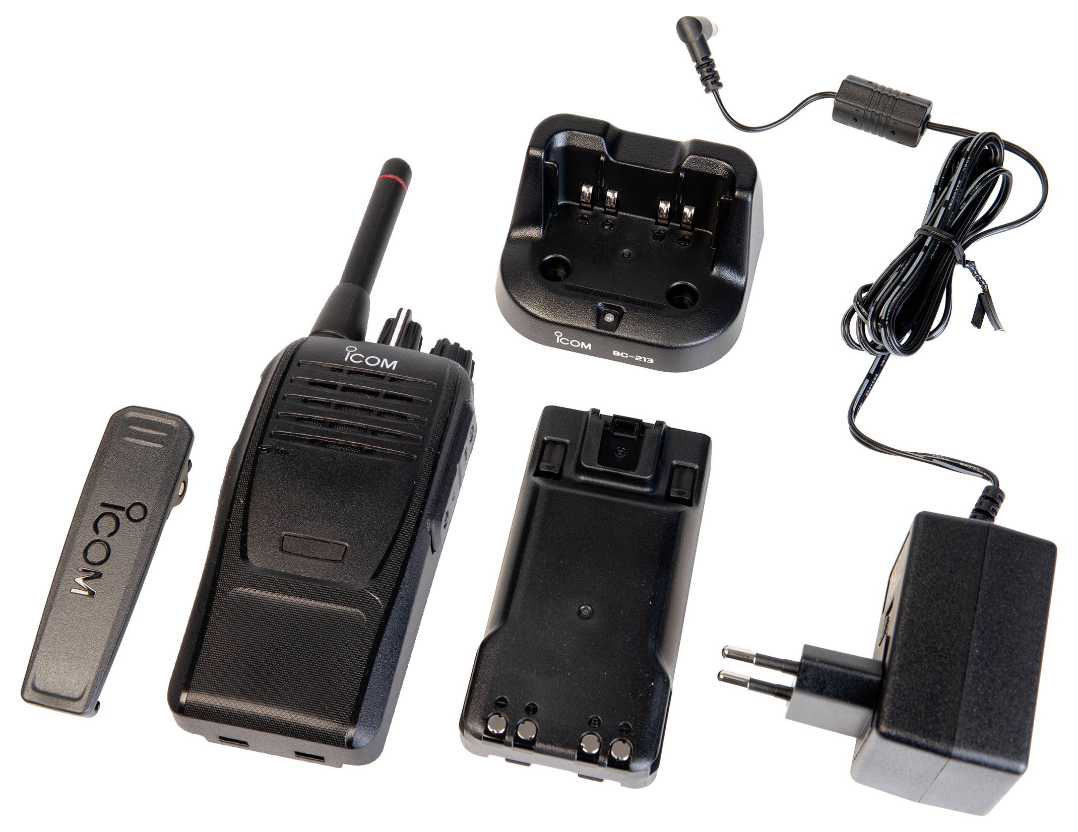 Icom tweerichting radiokit met handheldradio, riemclip, batterijpak, oplaadwieg en stroamadapter met kabel.