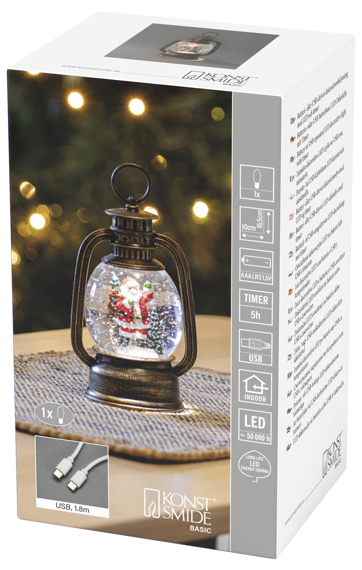 Produktdoos voor een Konstsmide Basic LED-lantaarn met een kerstman-sneeuwbol binnenin, gelabeld timer 5u, USB en binnengebruik.