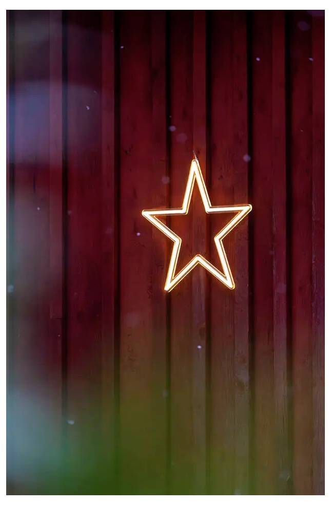 Gloeiend neonsterrenlogo gecentreerd op een donkere houten muur met rood en groen licht.