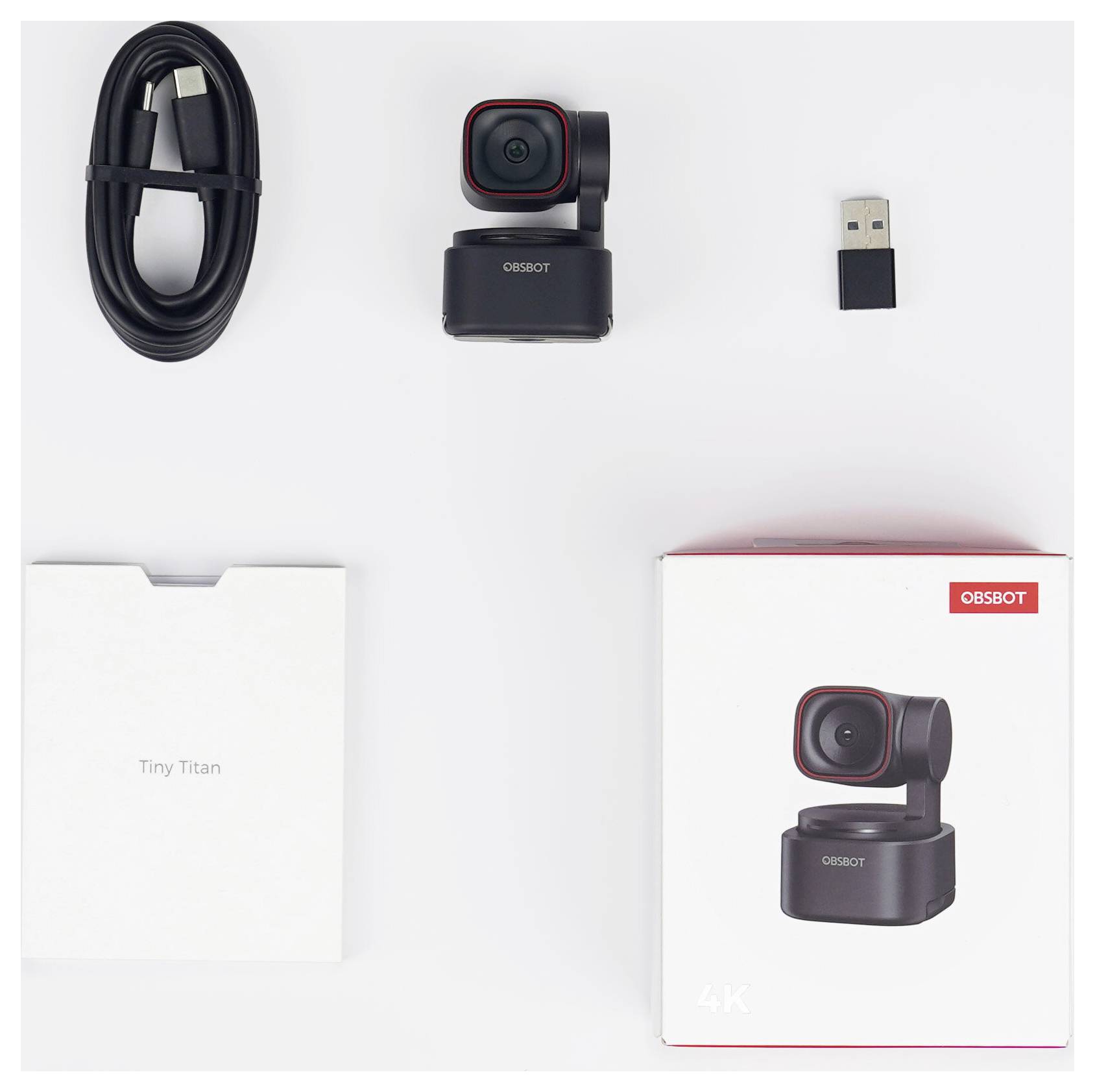 OBSBOT Tiny Titan 4K-webcamset met camera, USB-C-kabel, USB-ontvanger en verpakkingsdoos op witte achtergrond.