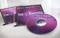 Meerdere cd-hoesjes en een cd met het opschrift 'be Events Sales Meeting 2014' in paarse en roze tinten.