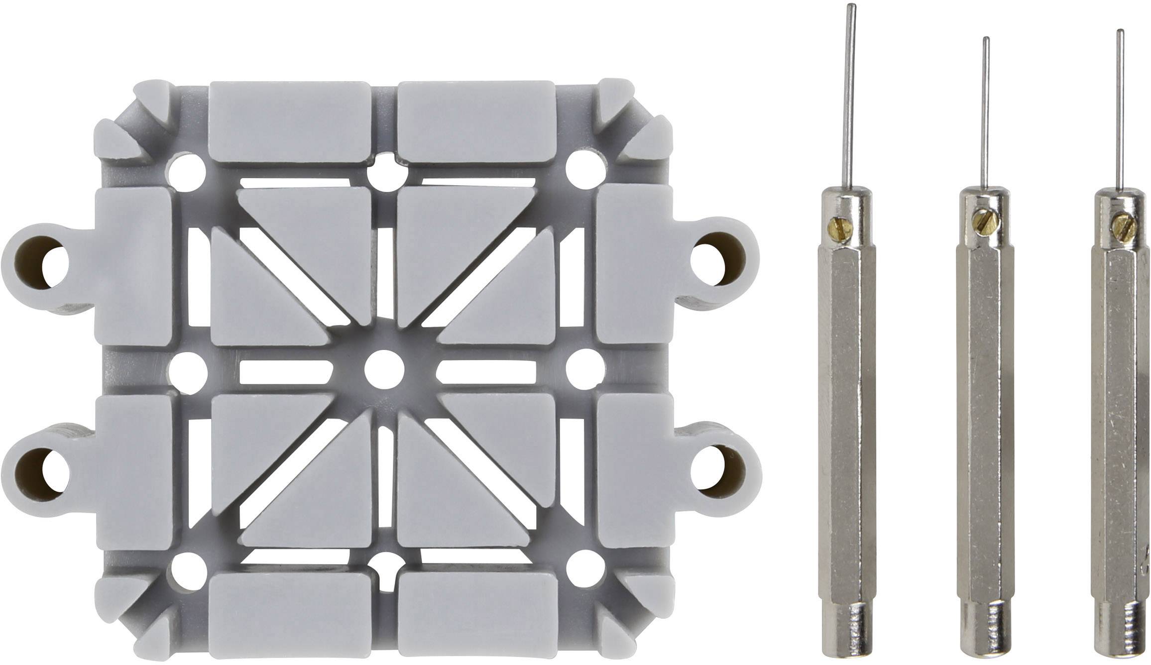 Grijs rastermodule met bevestigingsgaten links; ernaast drie precisie-instrumenten van metaal met naalden. Gereedschappen klaar voor gebruik.