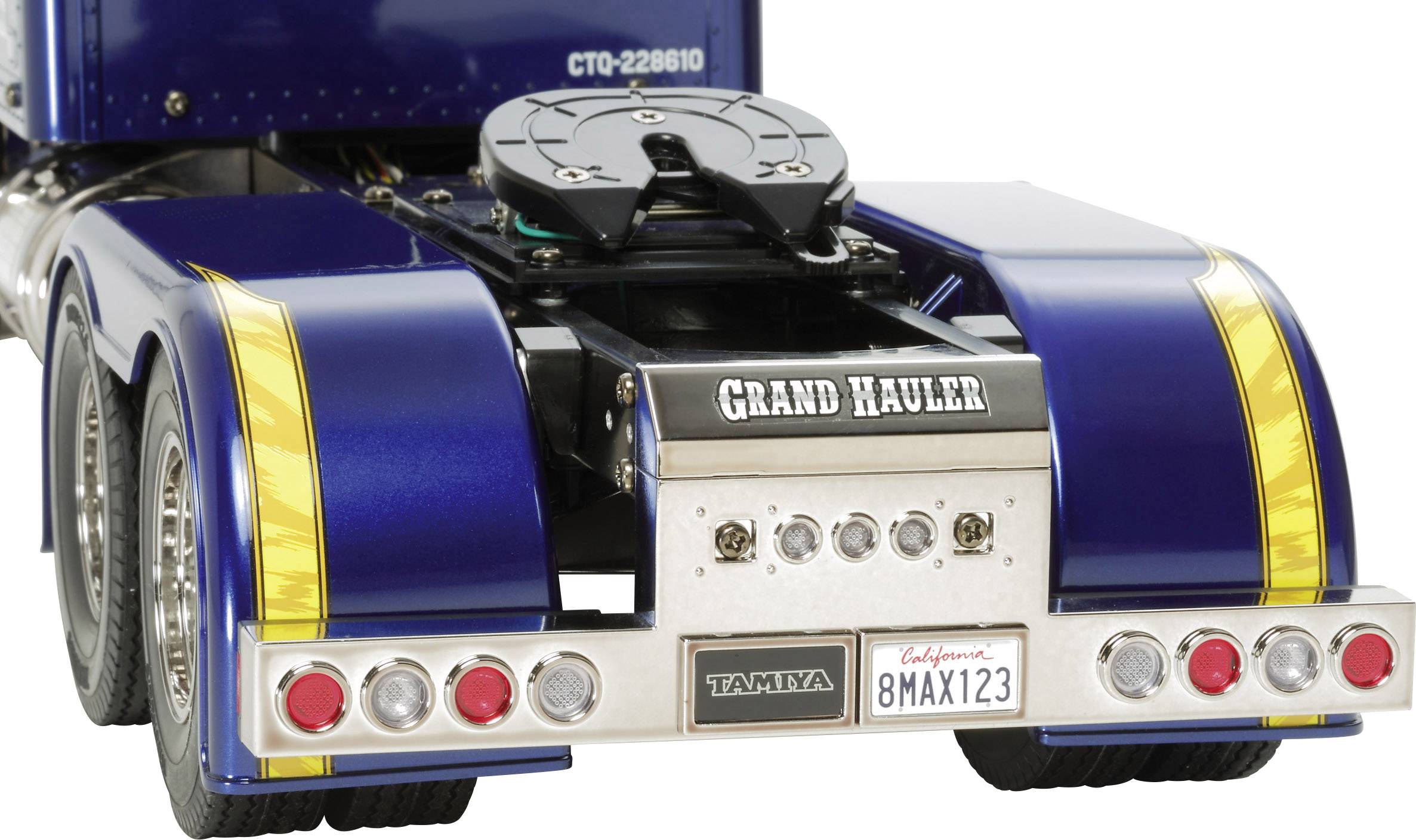 Close-up van de achterkant van een blauwe model-vrachtwagen met 'Grand Hauler' opschrift. Zichtbare chroomdetails en achterlichten.