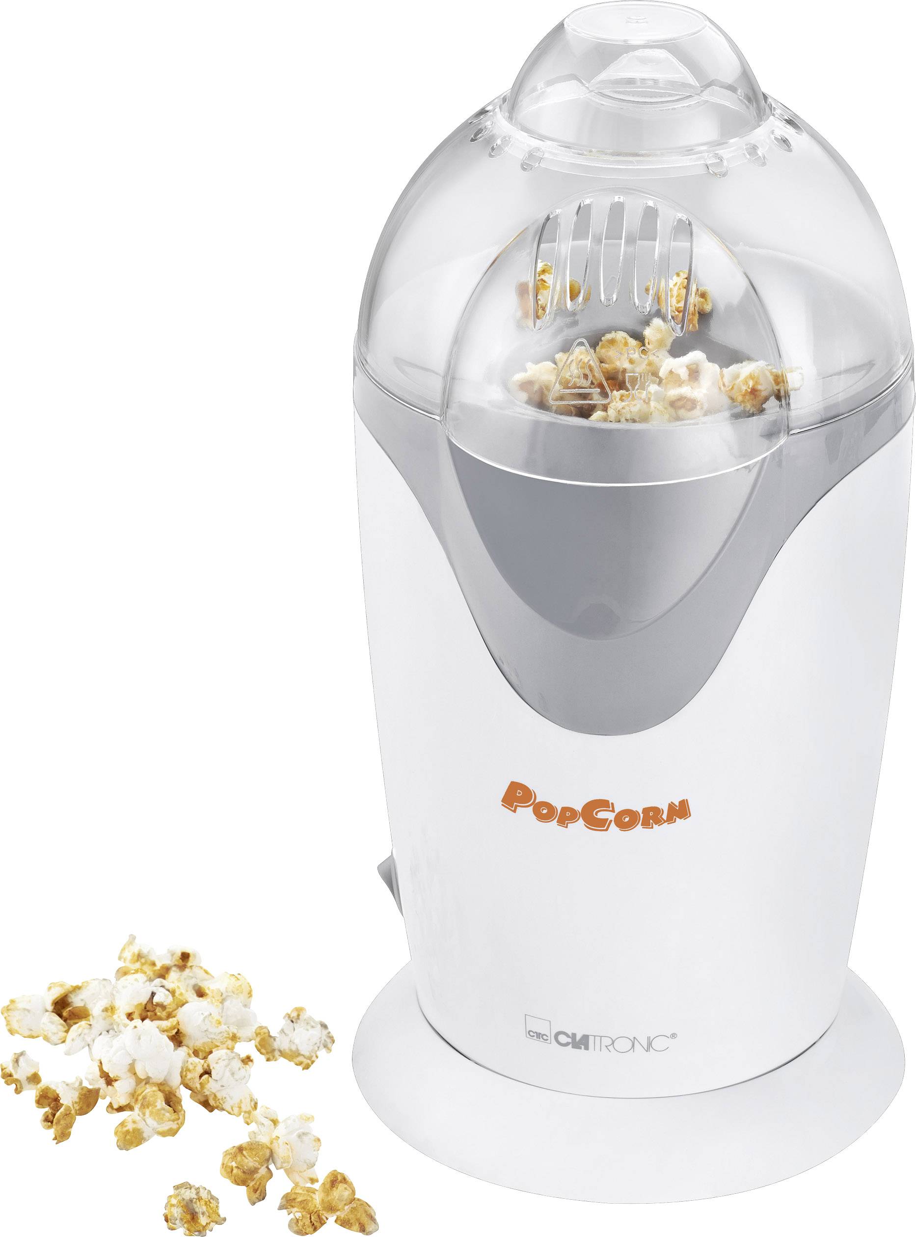 Elektrische popcornmachine met transparante deksel. Binnenin is vers, gepoft popcorn zichtbaar. Enkele popcornstukken liggen ernaast.