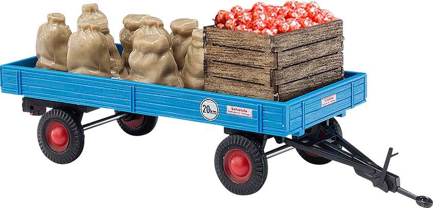 Een blauwe aanhanger met rode wielen, beladen met zakken en een houten kist vol rode appels.