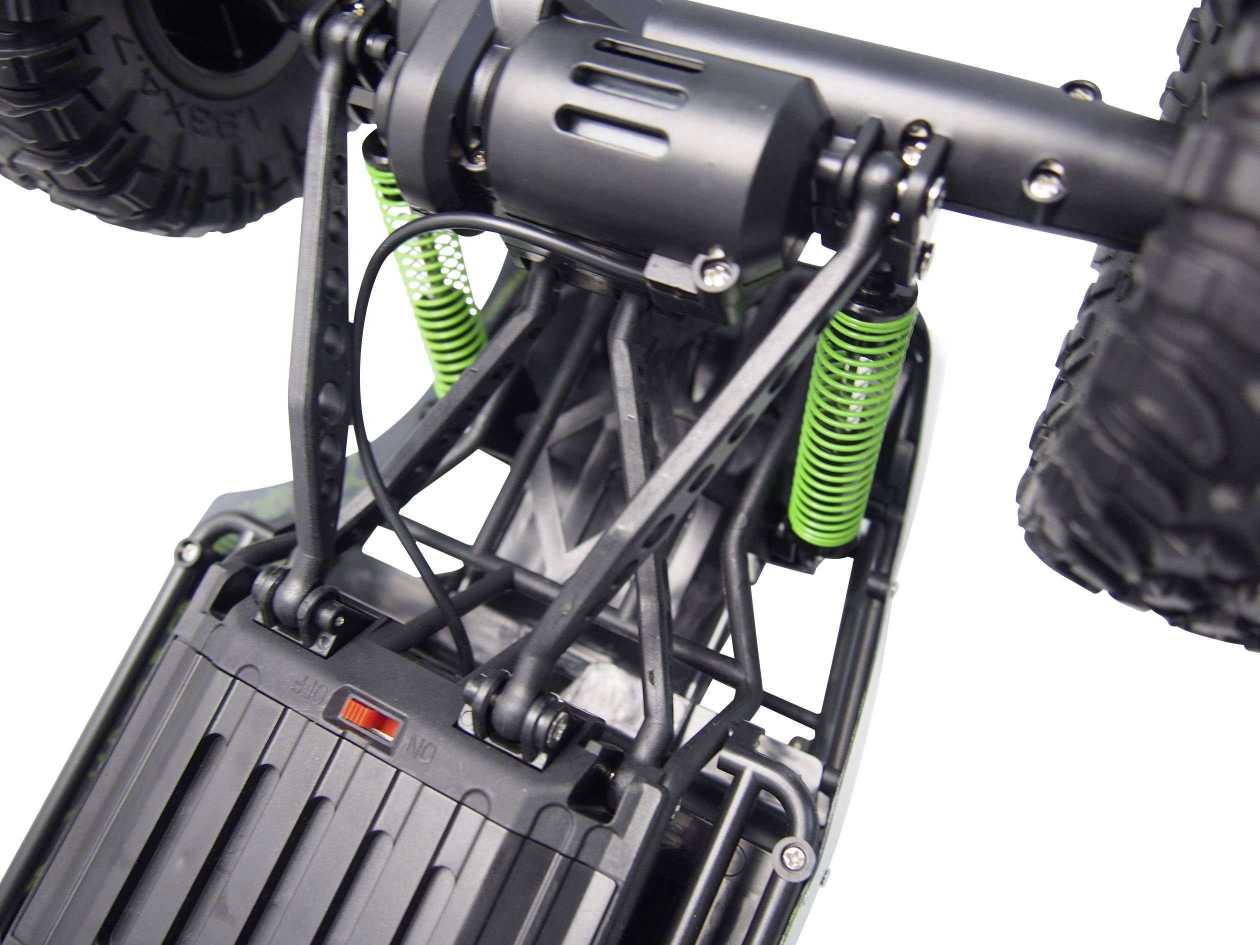 Close-up van de wielophanging en vering van een bestuurbaar voertuig, met groen gemarkeerde veren.