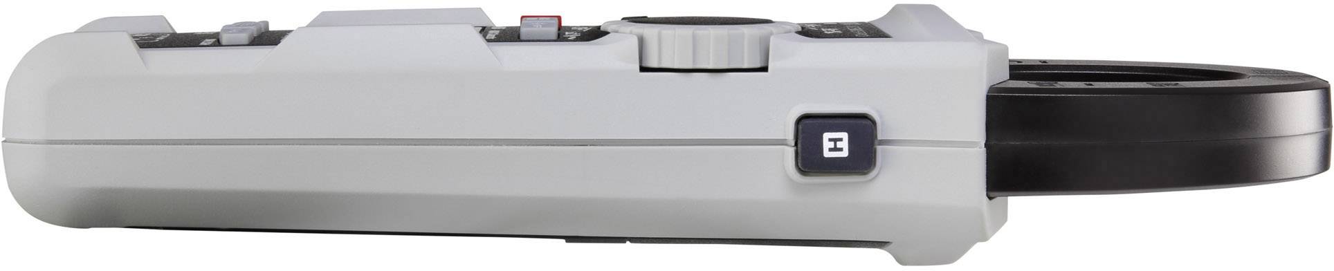 Een grijs elektronisch apparaat met een zwarte ring aan de zijkant, vermoedelijk een technisch meetinstrument, gefotografeerd vanuit een zijaanzicht.