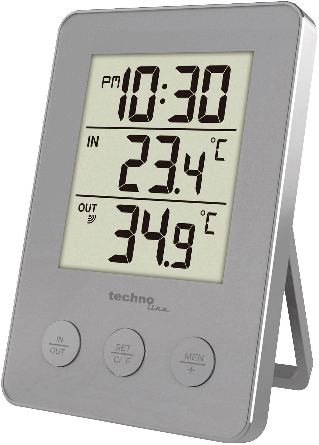 Digitale thermometer toont tijdstip 'PM 10:30', binnentemperatuur 23,4°C en buitentemperatuur 34,9°C.