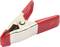 Een zilveren metalen klem met rode kunststof handgrepen ligt open op een witte oppervlakte.