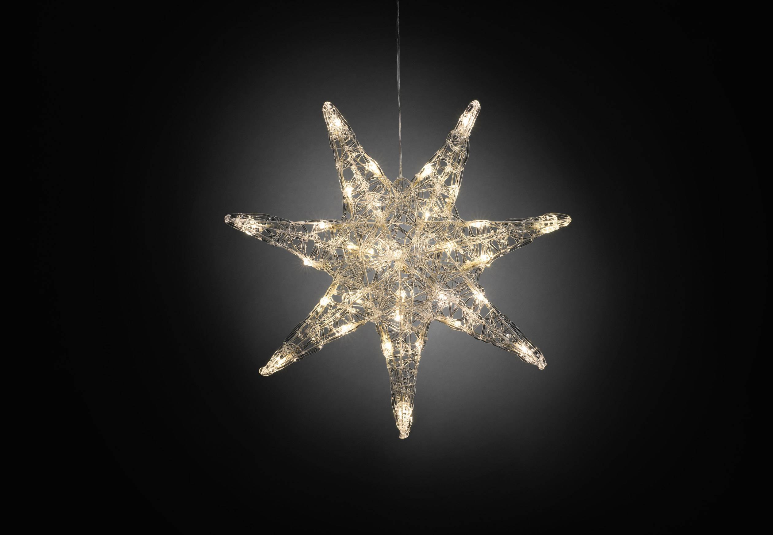 Een helder schijnende, stervormige hanglamp met acht punten tegen een zwarte achtergrond.