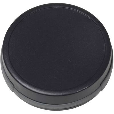 Een zwarte, ronde dop, waarschijnlijk een lensdop, ligt plat op een oppervlak.