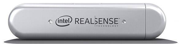 Een zilveren Intel RealSense camera, cilindrische vorm, ligt horizontaal.