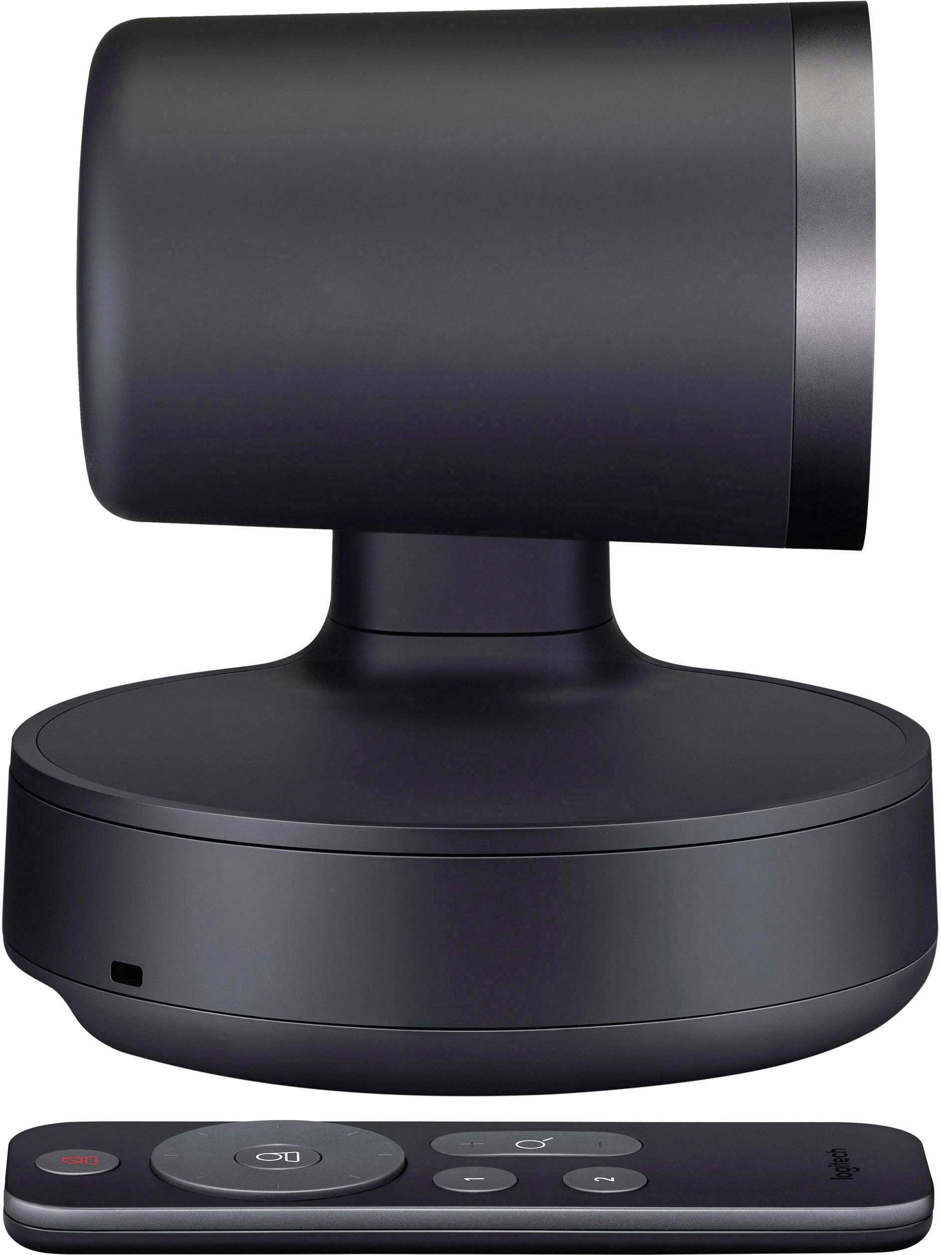 Een zwarte, gemotoriseerde camera staat op een rond voetstuk. Ervoor ligt een kleine afstandsbediening met meerdere knoppen.