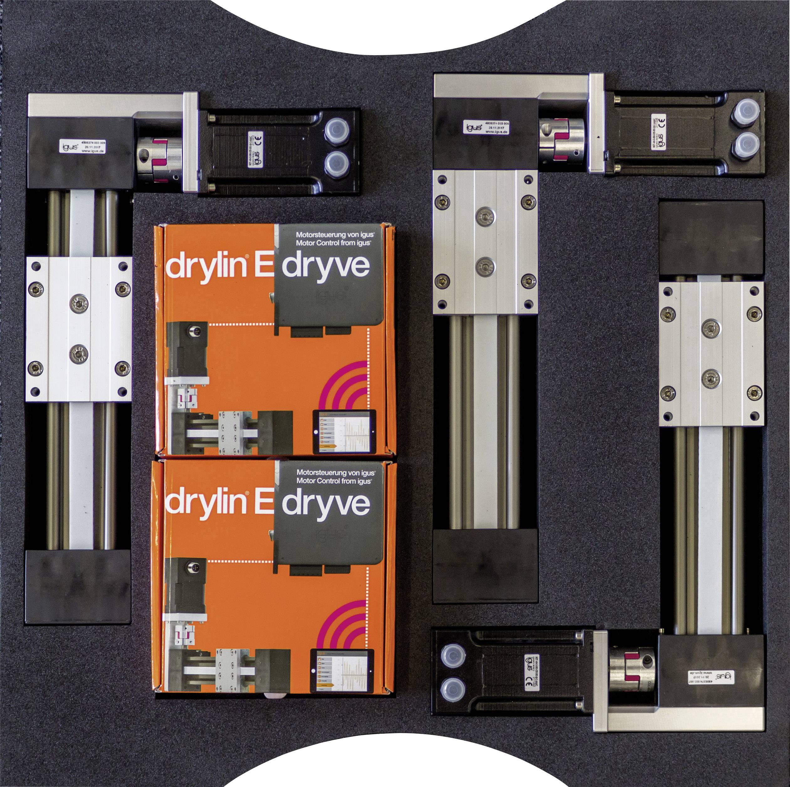 Motorbesturingen bevestigd op metalen platen, met twee oranje 'drylin E' dozen in het midden. Opstelling vormt de letters 'IG'.