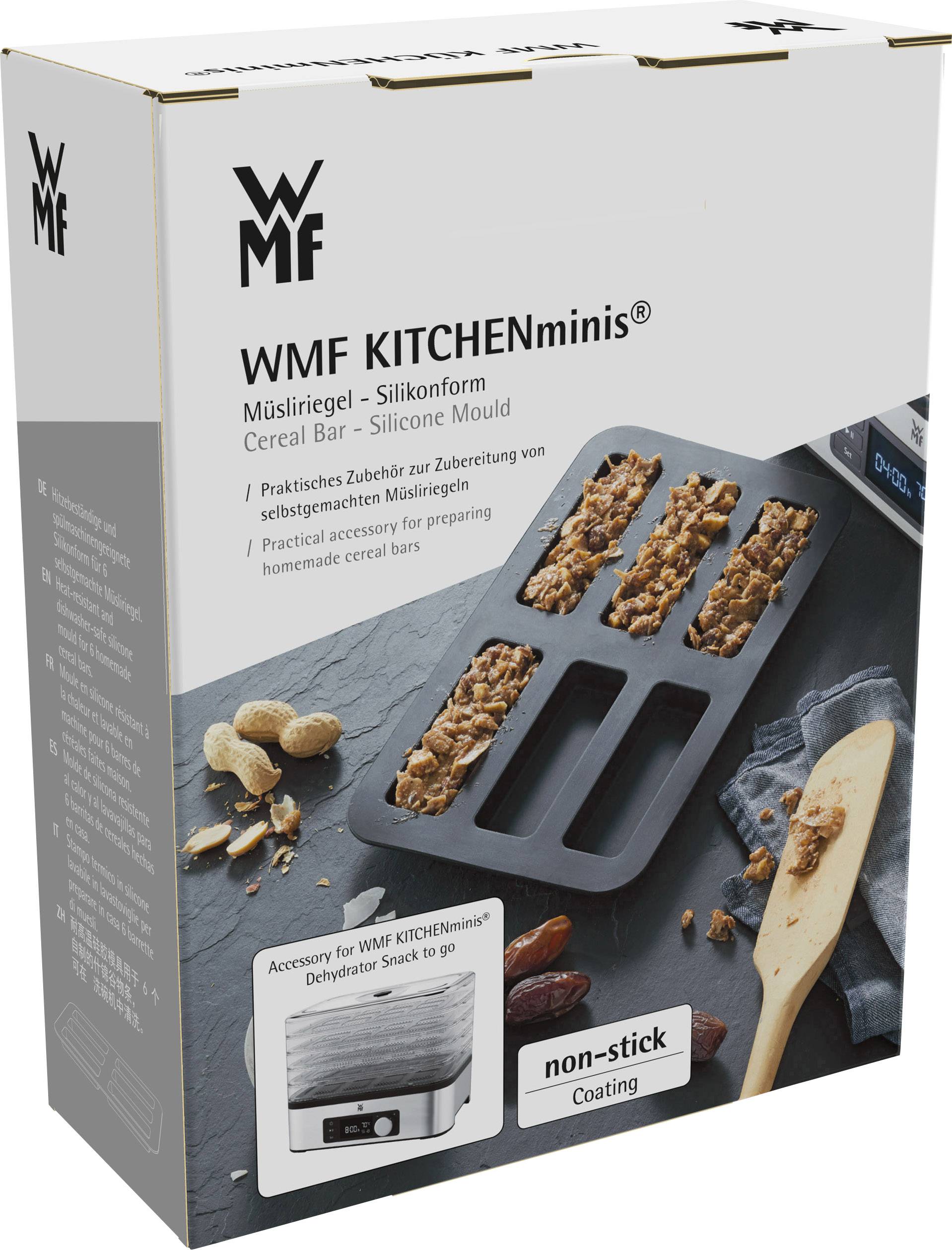 Verpakking van WMF KITCHENminis siliconen vorm voor muesli-repen met afbeelding van de vorm, afgewerkte repen en toebehoren op grijze ondergrond.