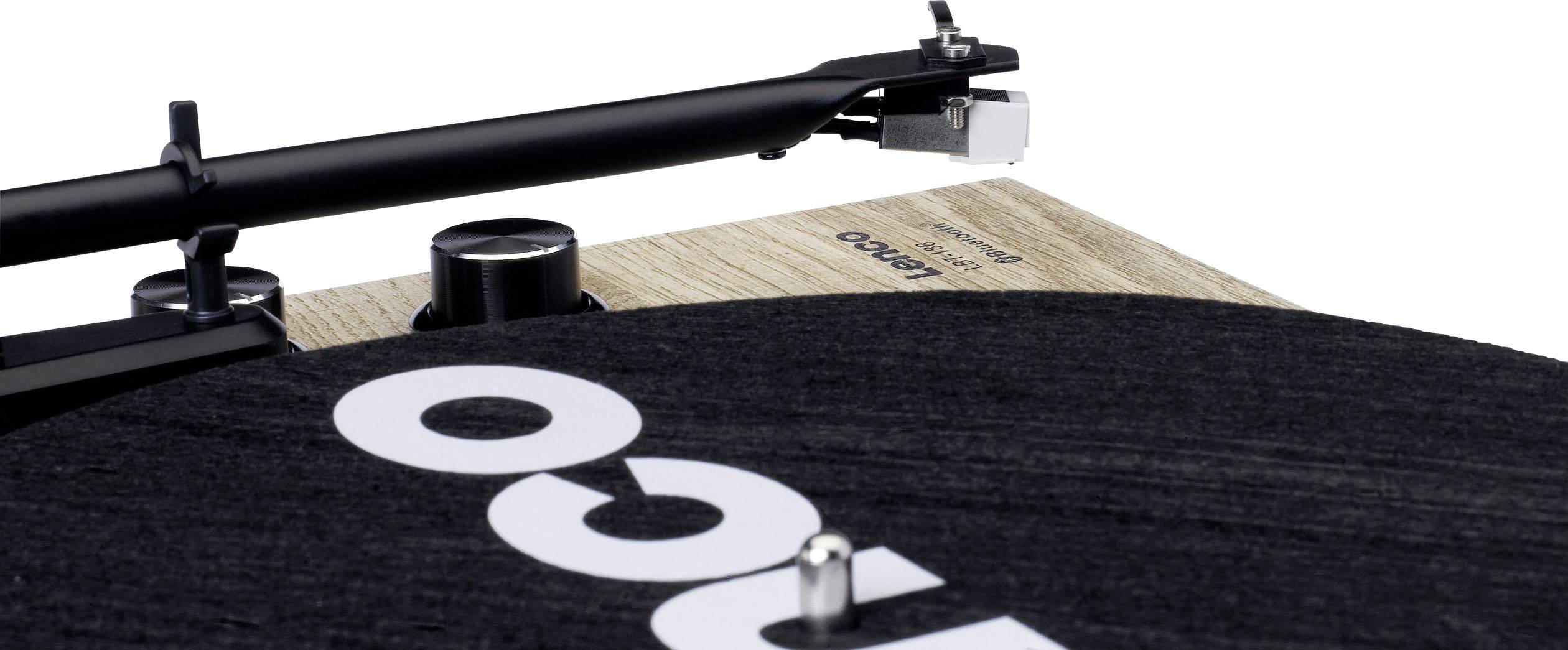 'Close-up van een platenspeler met houten details en een toonarm boven een zwarte vinylplaat.'