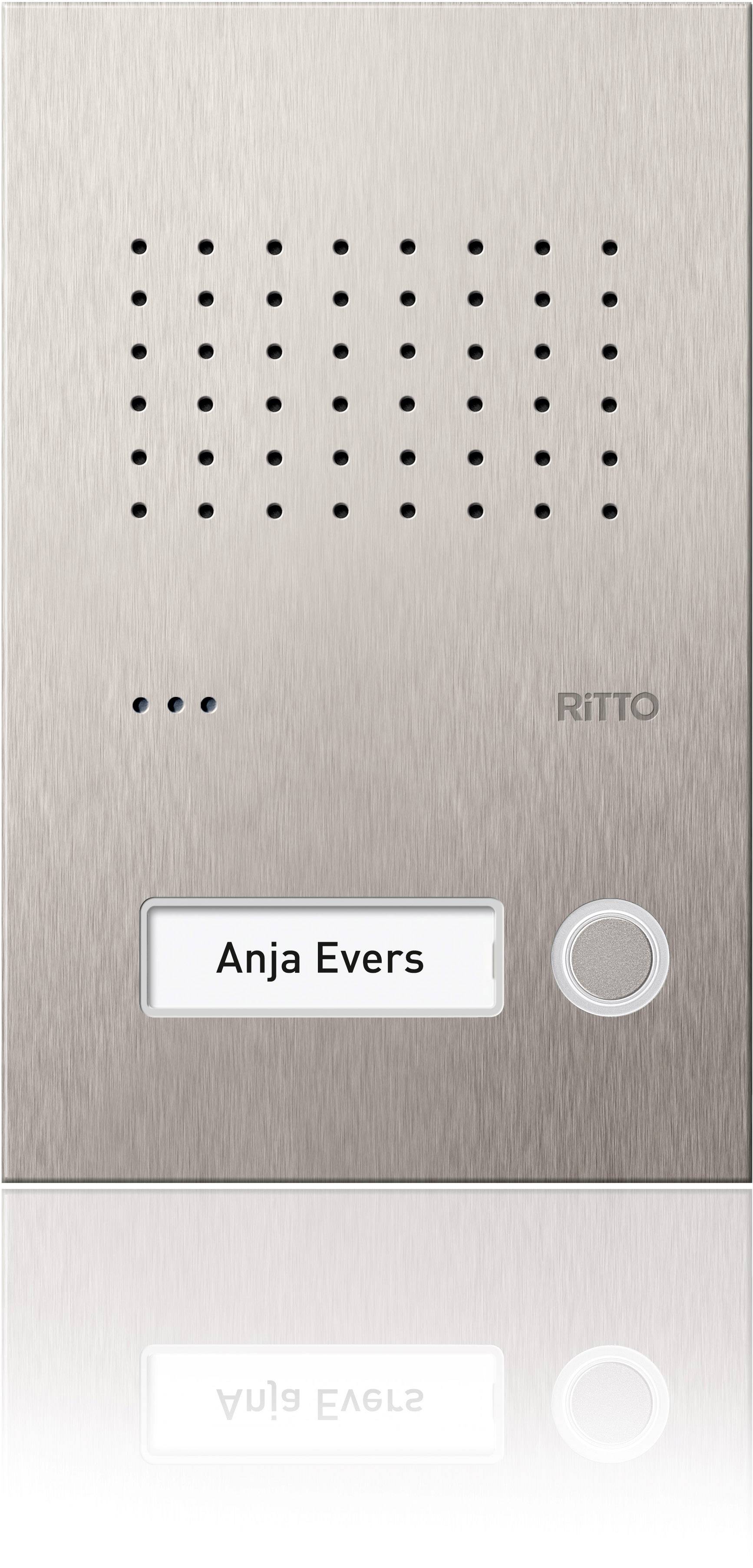 Roestvrij stalen intercom met luidspreker, camera en belknop. Opschrift vermeldt 'Anja Evers'.