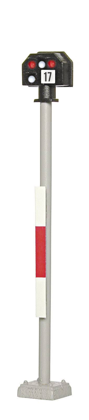 Spoorwegsignaal met nummer '17' en drie lampen: twee rode, één witte. Staat op een grijze paal met een wit-rood bord.