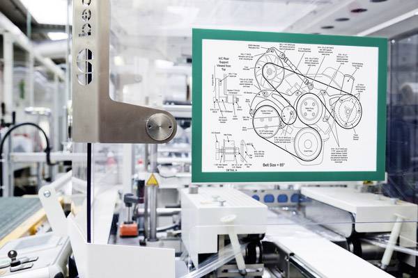 Een industriële machine in een fabriek die werkt met een technisch diagram van een riemschijf-configuratie op een scherm.
