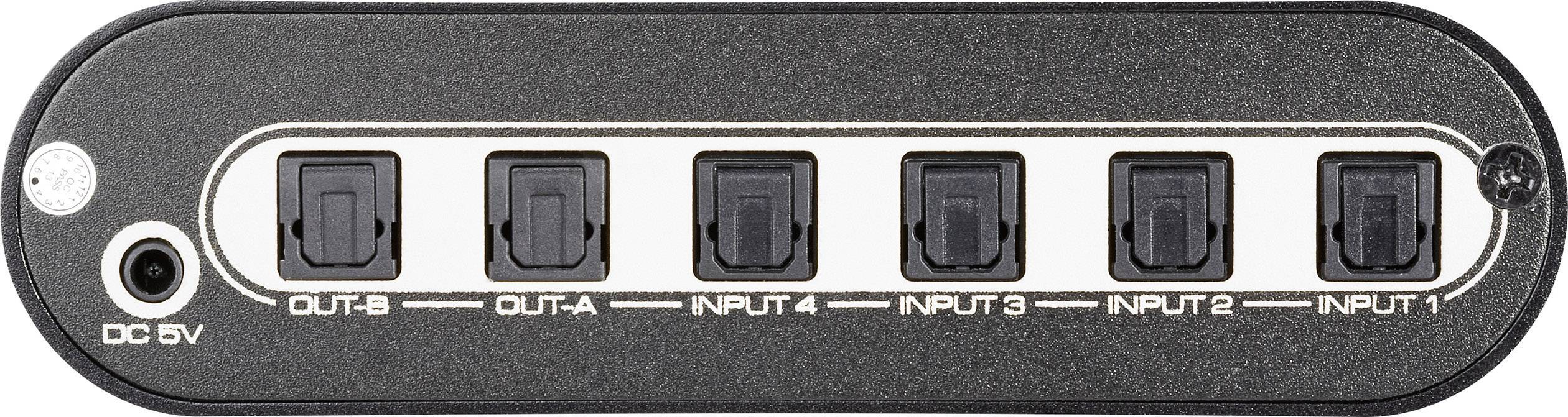 Een zwart elektronisch apparaat met zes aansluitingen, twee gemarkeerd als 'OUT' en vier als 'INPUT', evenals een DC 5V stroomaansluiting.