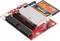 'Rode elektronische printplaat met een sleuf voor een CompactFlash-kaart. Bevat meerdere aansluitingen en elektronische componenten.'