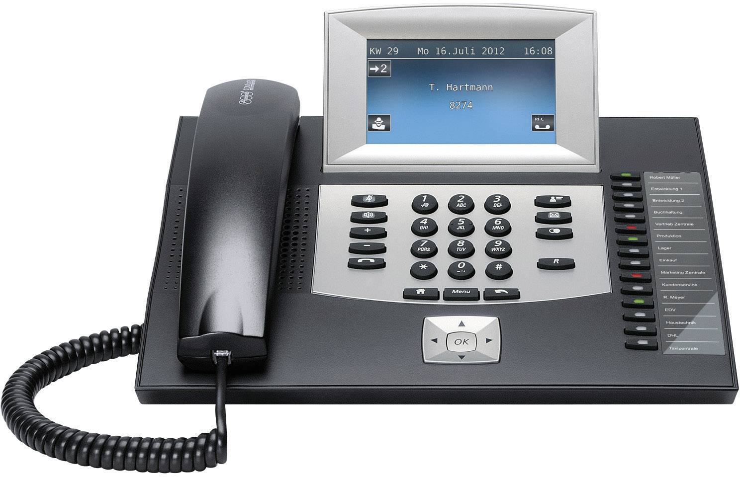 Zwart telefoontoestel met display toont datum '16 juli 2012' en naam 'T. Hartmann'. Toetsenbord en hoorn op de voorgrond.