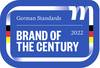 Logo na niebieskim tle przedstawia napis 'German Standards' oraz 'Brand of the Century 2022' z małymi flagami niemieckimi po bokach.